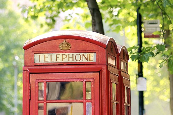 A pair of red telephone booths in London, England.