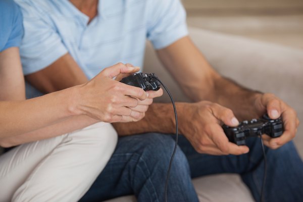 Close-up of friends playing video game