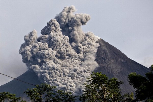 A pyroclastic flow sweeps down the side of a volcano