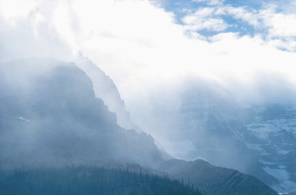 Inclement weather can appear over a mountain from a clear blue sky.