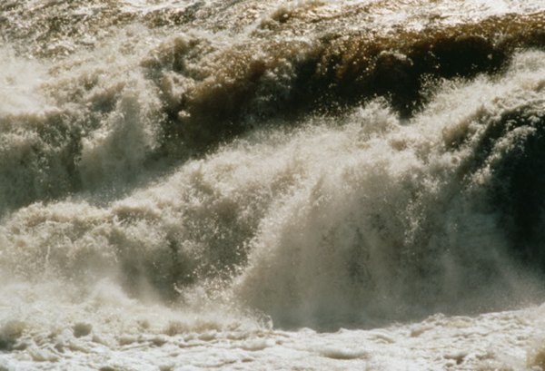 The power of water along coastlines and riverbanks changes land contours.