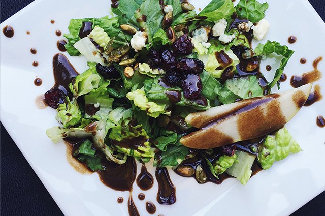 An image of a salad dressed with balsamic vinegar.