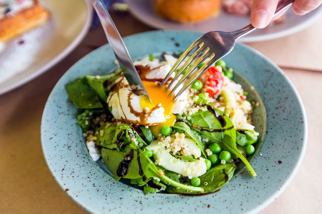 Poached egg over bed of greens and quinoa