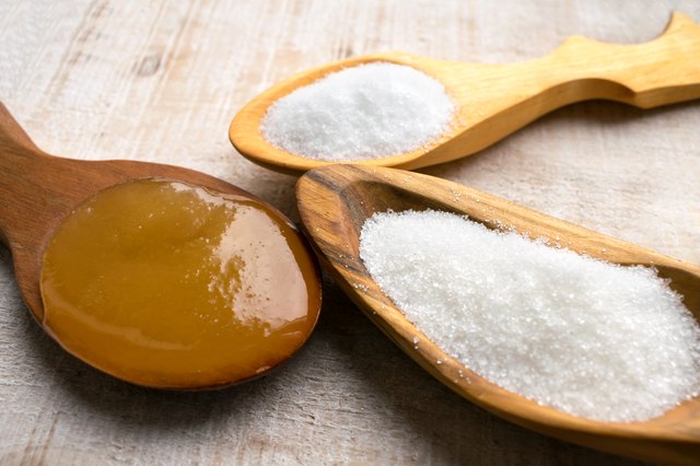 Artificial Sweeteners and Sugar Substitutes in wooden spoons. Natural and synthetic sugarfree food additive: sorbitol, fructose, honey, Sucralose, Aspartame
