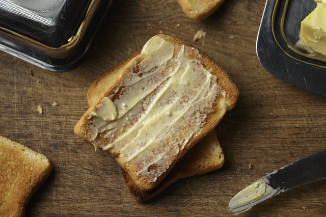 Crust toast bread and butter on a wooden background