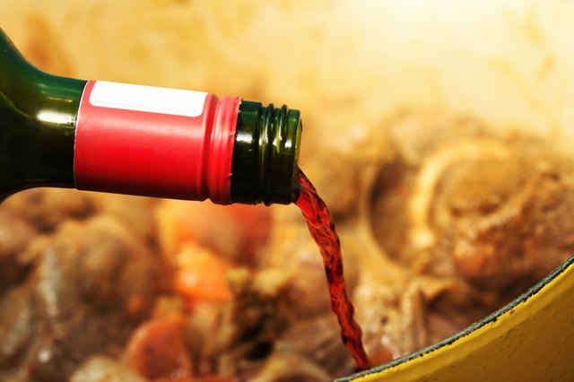 Red wine being added to simmering beef stew