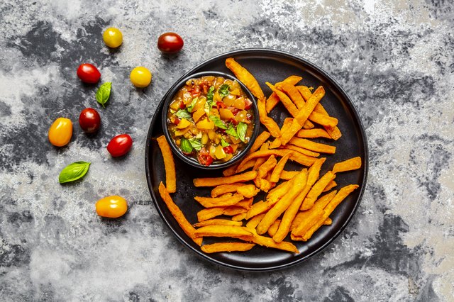 Homemade sweet potato fries and bowl of tomato basil dip