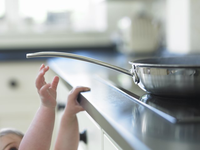 Baby reaching for hot frying pan on stove