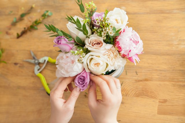 Crop hands of florist making bouquet