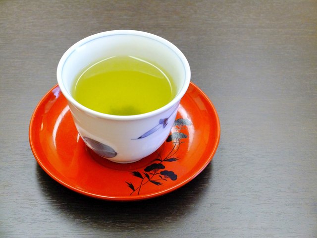 Green tea in a cup with saucer
