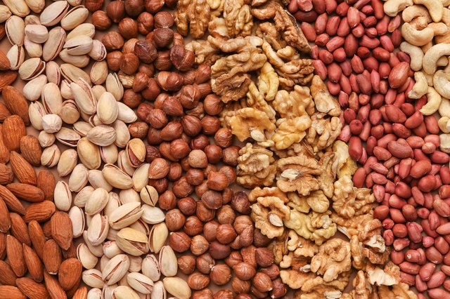 Texture of assorted nuts in rows, closeup