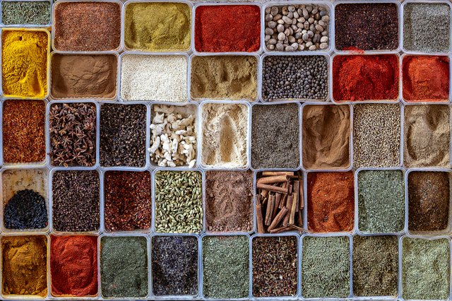 Display of different sort of spices in boxes.