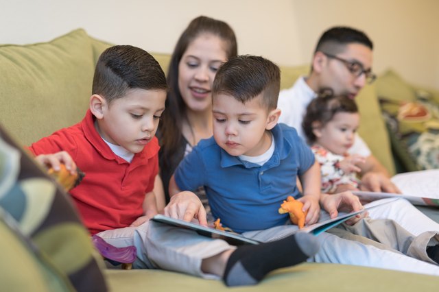 Hispanic family reading together on the couch