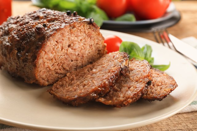 Close view of sliced meatloaf on a white plate