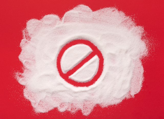 Stop prohibition sign on white sugar background