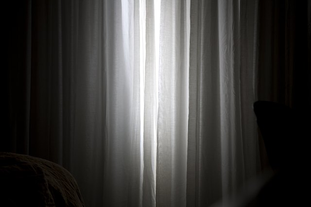 Sunlight coming in through slightly parted curtains in a bedroom