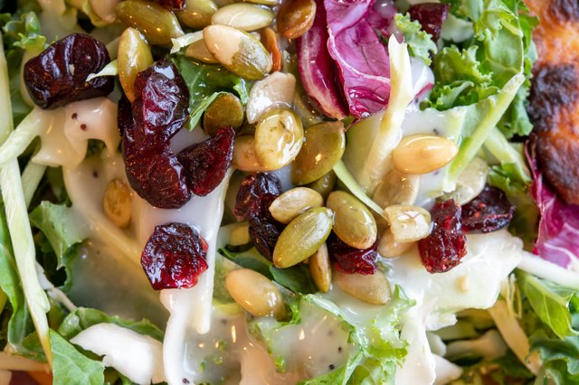 Kale Salad with pumpkin seeds and craisins on top