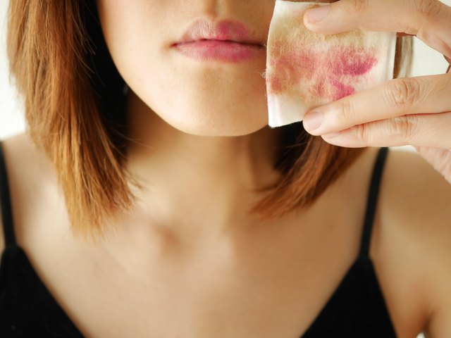 young woman remove make up by cotton pad and cleansing wipe on face, lips,eyes.