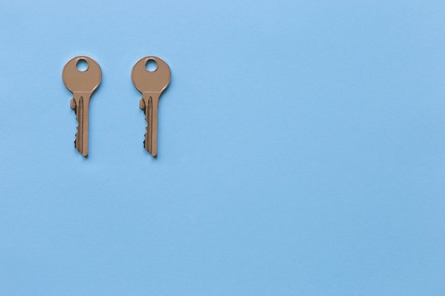 Close-Up Of Keys Over Blue Background