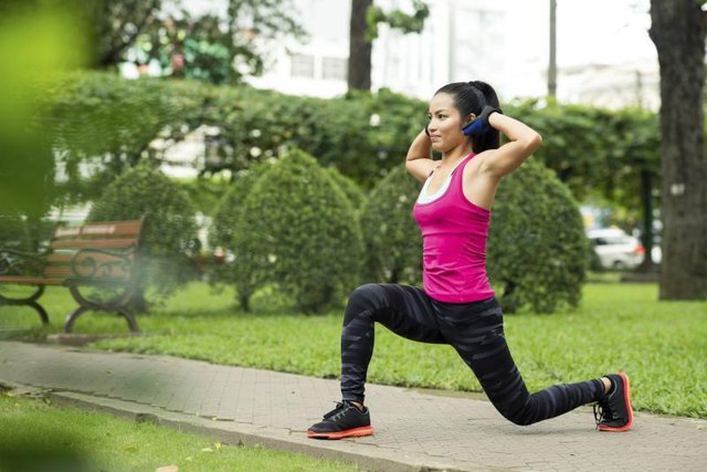 Woman practicing lunges outside.