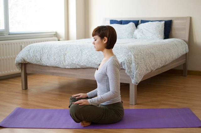side profile of a young woman practicing yoga