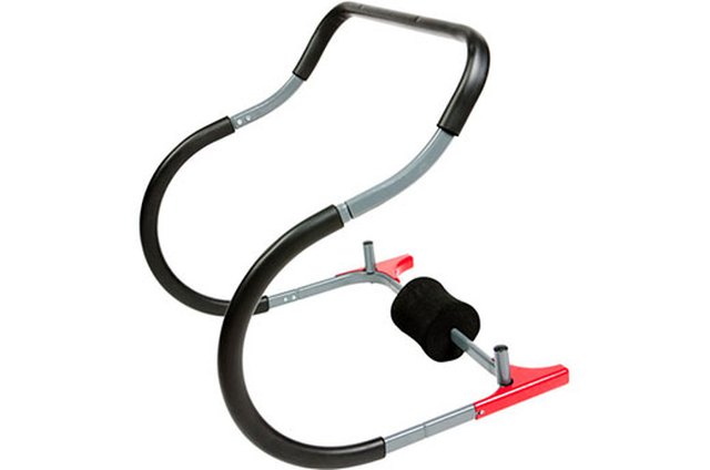 Portrait of man using exercise equipment in gymnasium