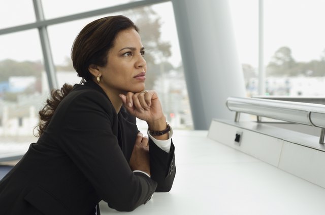 Hispanic businesswoman thinking