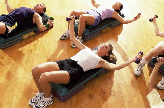 High angle view of five people exercising in a step aerobics class