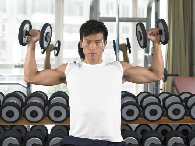 Man lifting weights in gym.