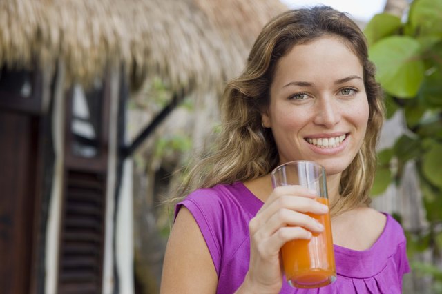 Woman with glass of juice outdoors