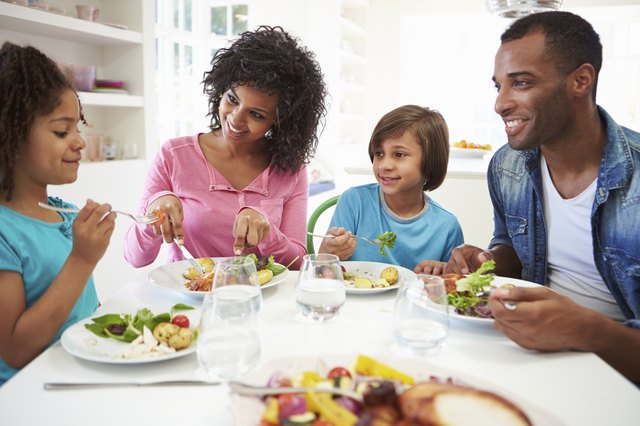 African American Family Eating Meal At Home Together