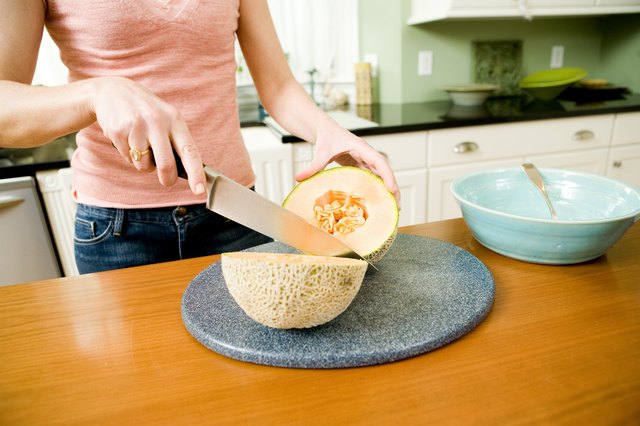 Woman slicing cantaloupe