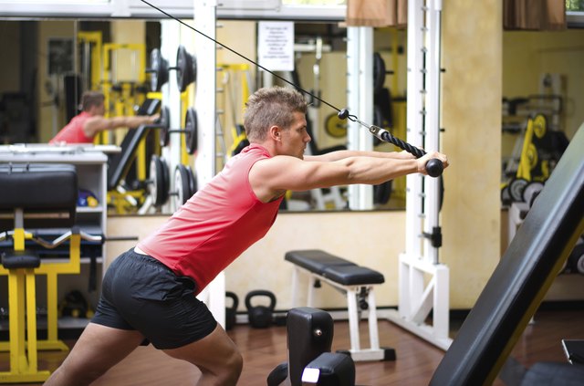 Young man training on gym equipment