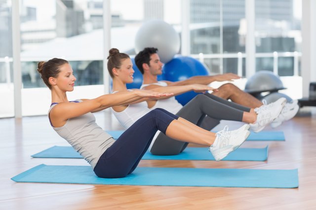 Class stretching on mats at yoga class