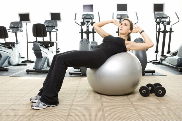 Woman doing sit-ups on exercise ball