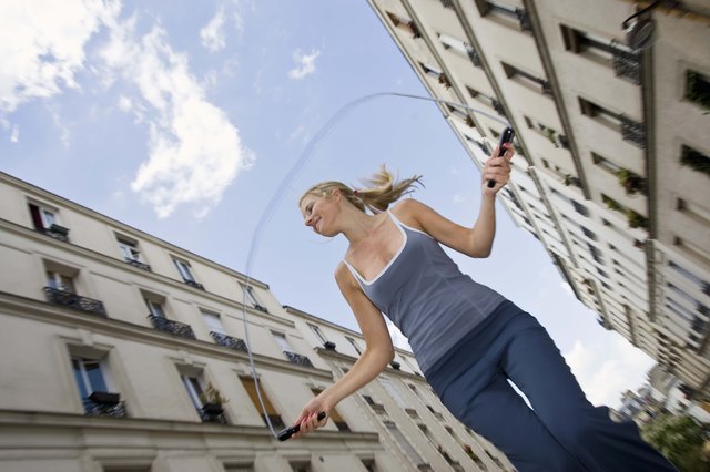 Woman jumping rope in city