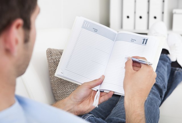 Man Writing In Diary