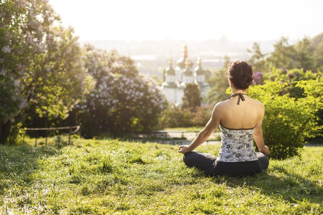Young Caucasian woman meditating outdoors