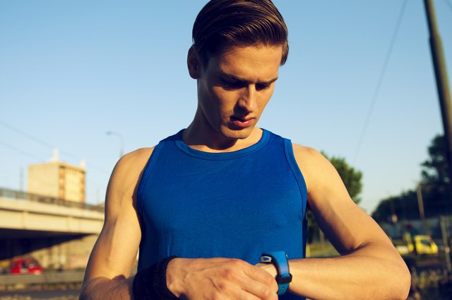Handsome athlete checking pulse