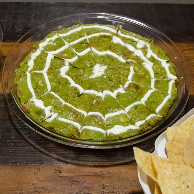 Guacomole topped with a sour cream spider web