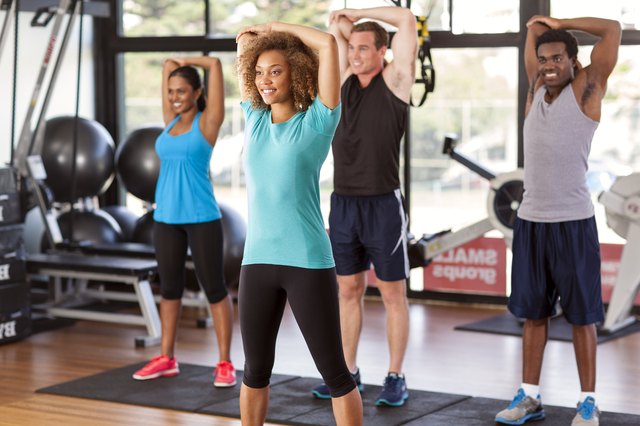 Multi-ethnic group stretching in a gym