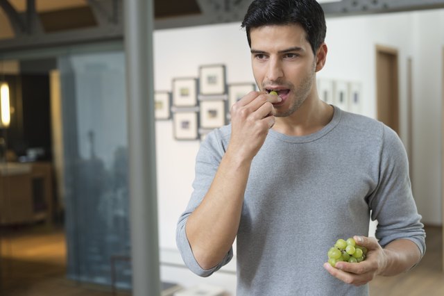 Man eating grapes