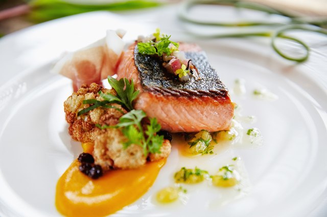 Close up of plate of fresh grilled fish and sauce