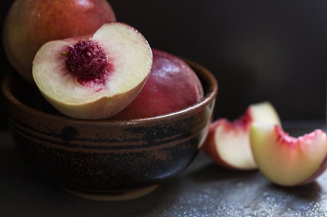 Fresh peaches and nectarines on a dark background