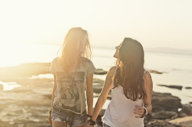 Young friends on beach at sunset