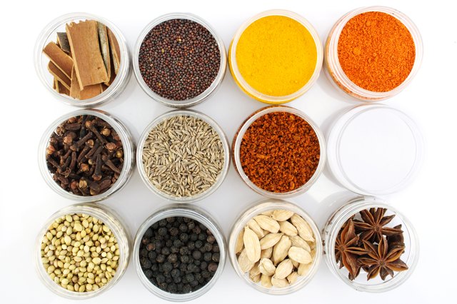 Variety of spices in plastic containers on a tabletop
