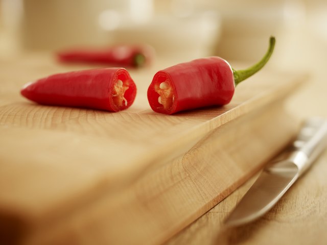 Close up of red chili peppers on cutting board