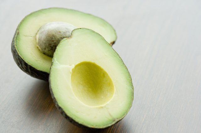 Halved avocado on tabletop, close up