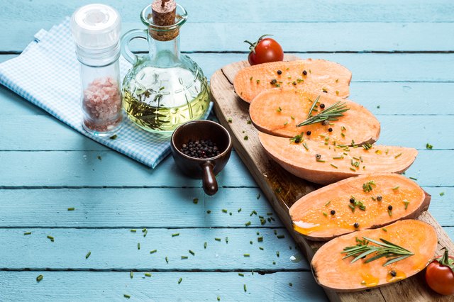 Raw sweet potatoes slice  on wooden background closeup