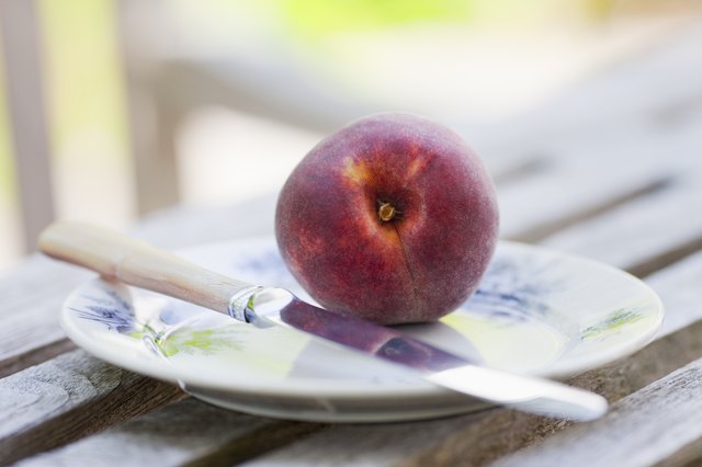 Peach on a plate with knife